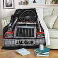Red semi truck throw blanket displayed on a couch with bold black, silver, and red trucker artwork