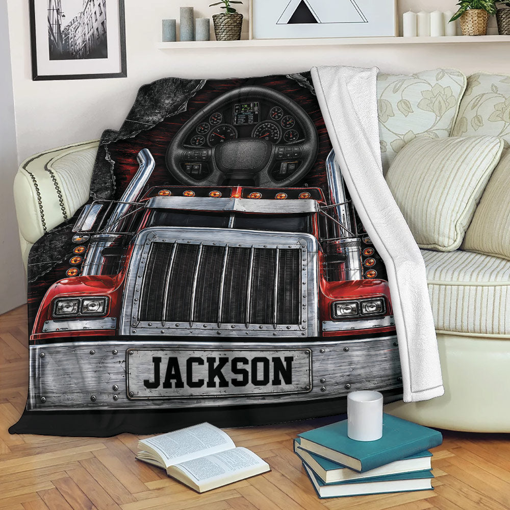 Red semi truck throw blanket displayed on a couch with bold black, silver, and red trucker artwork