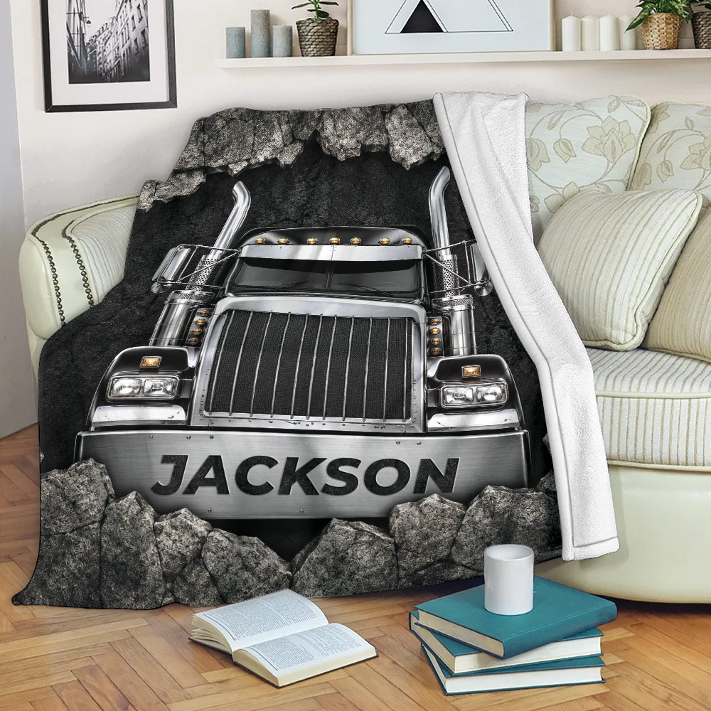 Custom trucker blanket displayed on a sofa with dramatic semi truck and rock artwork