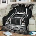 Semi truck throw blanket styled on a couch with bold chrome truck artwork and rugged stone details
