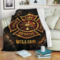 Firefighter blanket draped over a sofa, featuring a dramatic fire service emblem in red, gold, and black