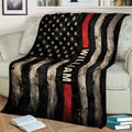 Thin red line firefighter throw blanket displayed across a sofa with distressed patriotic flag artwork