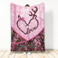 Pink deer throw blanket featuring antler artwork, a heart motif, bow detail, and camouflage forest print