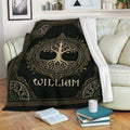 Celtic Tree of Life throw blanket displayed on a sofa with intricate green, black, and gold artwork