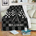 Black and gray racing throw blanket displayed on a sofa with crossed checkered flags