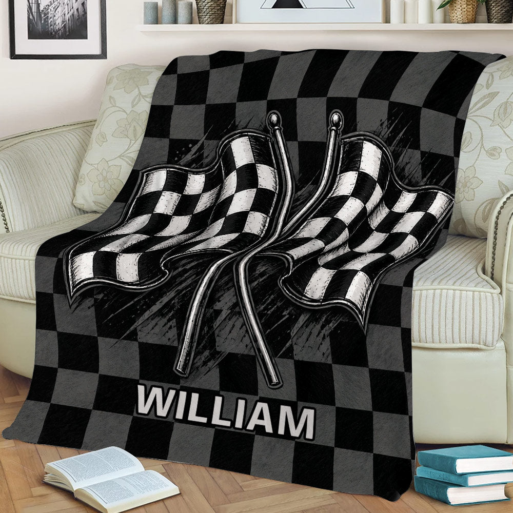 Checkered racing blanket draped over a couch with bold crossed flag artwork