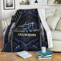 Trucker throw blanket draped over a sofa, featuring a blue semi-truck and patriotic black and blue artwork