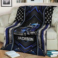 Blue semi-truck blanket displayed on a couch with star graphics, metallic textures, and bold industrial design