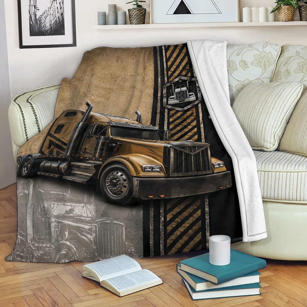Trucker blanket displayed on a sofa with bold semi truck artwork and an industrial road-inspired design