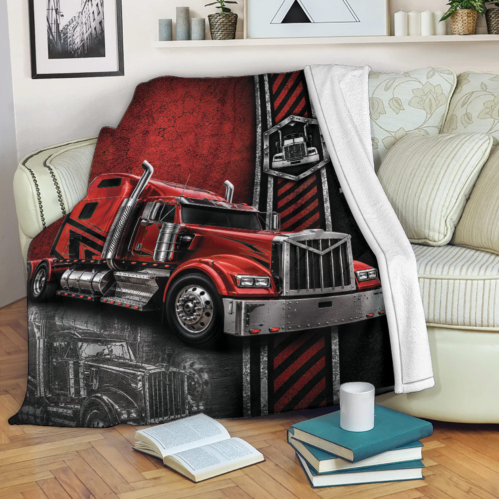 Red big rig Trucker blanket displayed across a sofa with bold black and red artwork