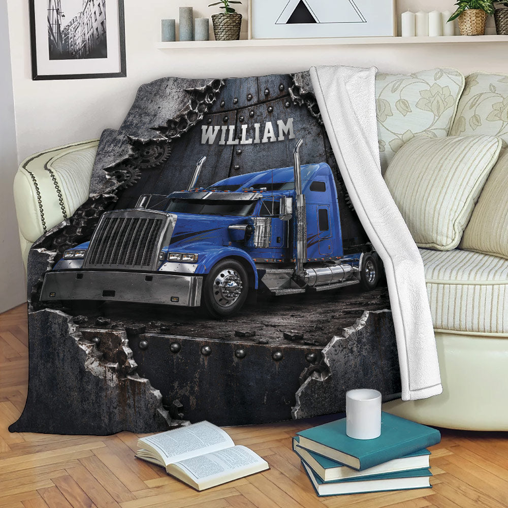 Blue semi truck blanket displayed across a sofa with bold industrial trucking artwork
