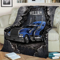 Trucker throw blanket draped over a sofa with blue big rig artwork and rugged gear details