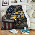 Trucker throw blanket displayed on a sofa with a yellow semi truck, American flag, and rugged industrial artwork