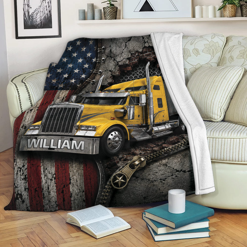 Trucker throw blanket displayed on a sofa with a yellow semi truck, American flag, and rugged industrial artwork