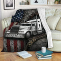 Trucker blanket draped over a sofa with a white big rig, American flag design, and rugged industrial details