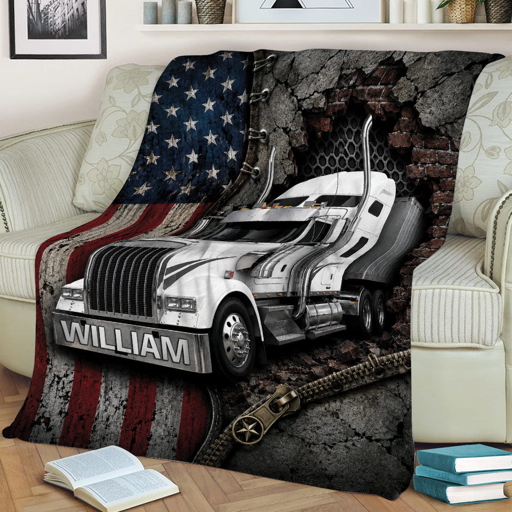 Trucker throw blanket displayed on a sofa with bold semi-truck artwork, distressed flag stripes, and zipper-inspired details
