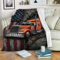 Trucker blanket draped over a sofa with orange semi truck artwork, American flag styling, and industrial accents