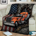 Large trucker throw blanket displayed across a sofa with bold orange semi truck and distressed patriotic artwork