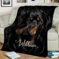 Rottweiler throw blanket styled on a sofa with dramatic black and tan dog artwork