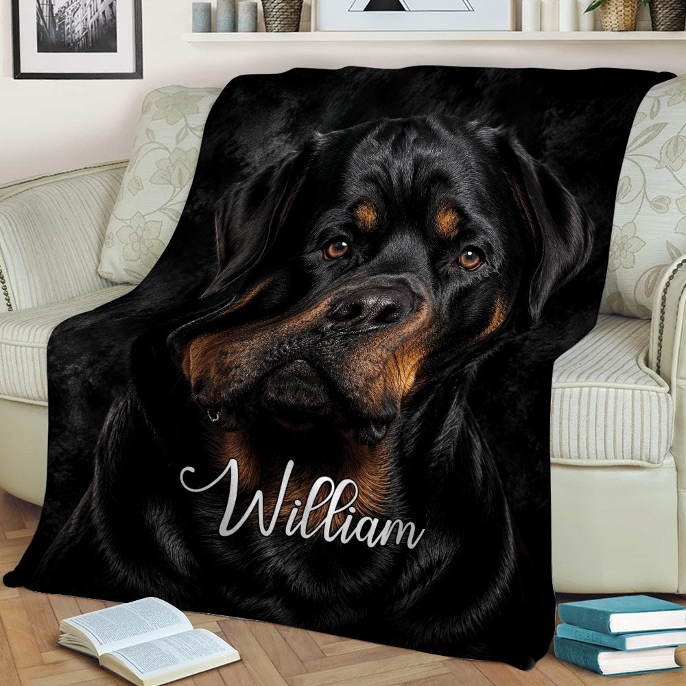 Rottweiler throw blanket styled on a sofa with dramatic black and tan dog artwork