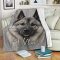Norwegian Elkhound throw blanket draped over a sofa in a cozy living room