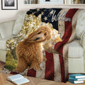 Patriotic Goldendoodle throw blanket draped over a sofa with a curly dog and American-inspired artwork