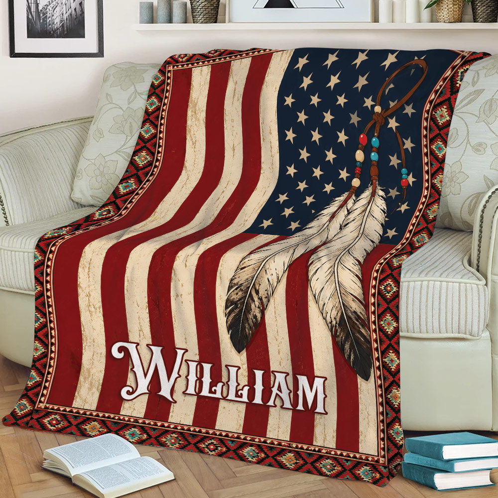American Native throw blanket draped over a couch with patriotic colors, feather artwork, and geometric trim