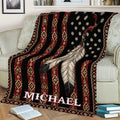 American Native-inspired blanket draped over a couch, featuring feathers, star details, and colorful geometric borders