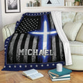 Police-themed throw blanket displayed on a sofa with thin blue line flag artwork and star border