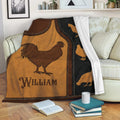 Rustic chicken throw blanket displayed on a sofa with rooster artwork and warm brown and black tones