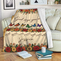 Christian floral throw blanket draped over a sofa with butterflies, scripture references and inspirational wording