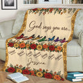 Faith-inspired floral blanket displayed on a couch with colorful butterflies and scripture-based affirmations