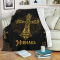 Christian cross blanket draped over a sofa, featuring ornate gold artwork on black