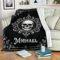 Gothic skull throw blanket draped over a sofa with ornate black and white artwork