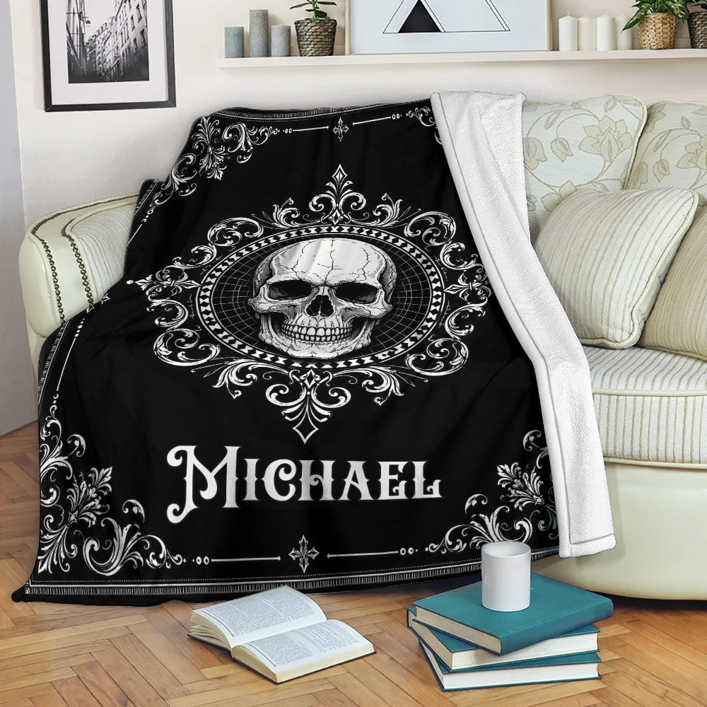 Gothic skull throw blanket draped over a sofa with ornate black and white artwork