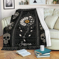 Floral skull throw blanket draped over a sofa with daisy wreaths and gothic-inspired black artwork