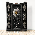 Floral skull throw blanket displayed upright with daisies, sunflowers, and dark decorative patterns