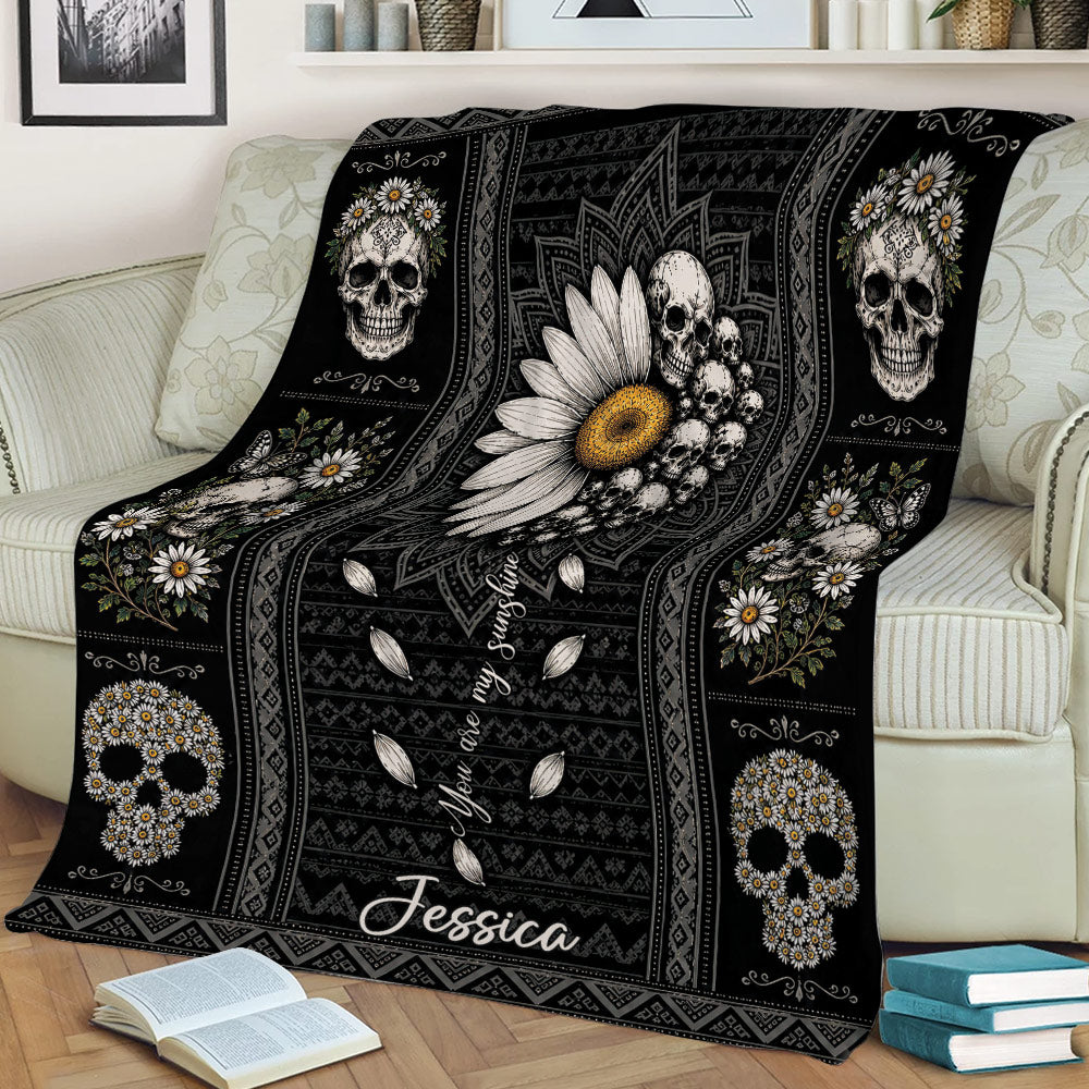 Gothic floral skull throw blanket styled across a sofa with dark ornamental patterns and flowers