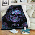 Skull throw blanket with vivid purple and blue mandala artwork draped over a living room sofa