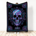 Colorful purple and blue skull blanket with mandala border displayed against a bright room backdrop