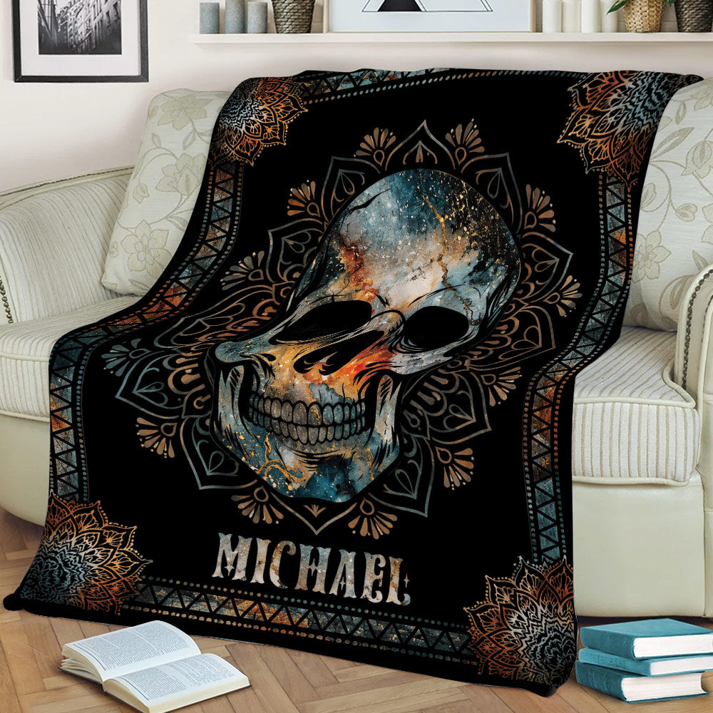 Decorative skull blanket draped over a couch with ornate geometric and mandala-inspired detailing