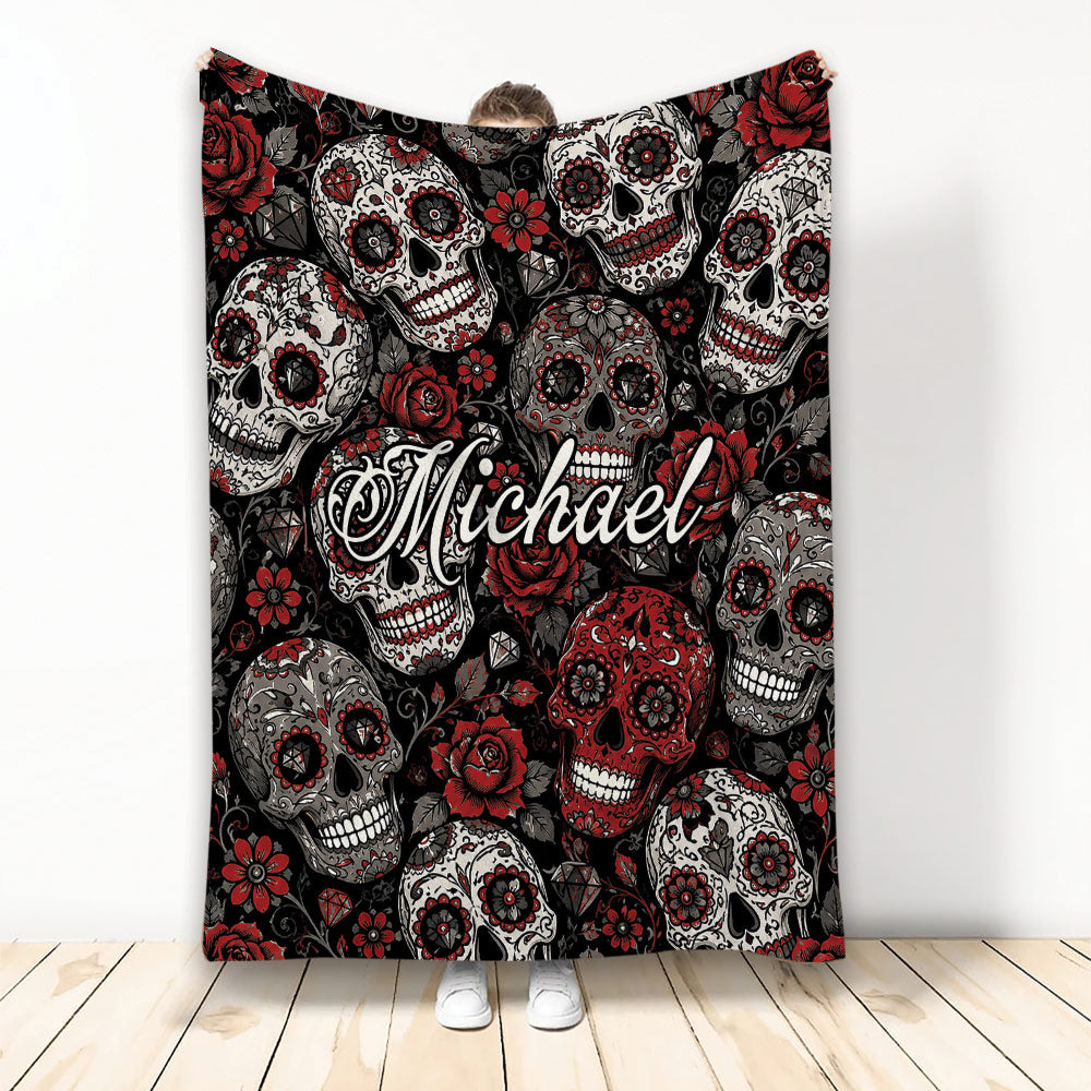 Skull throw blanket with decorative sugar skulls, red roses, black background, and gothic floral artwork