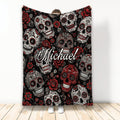 Skull throw blanket with decorative sugar skulls, red roses, black background, and gothic floral artwork