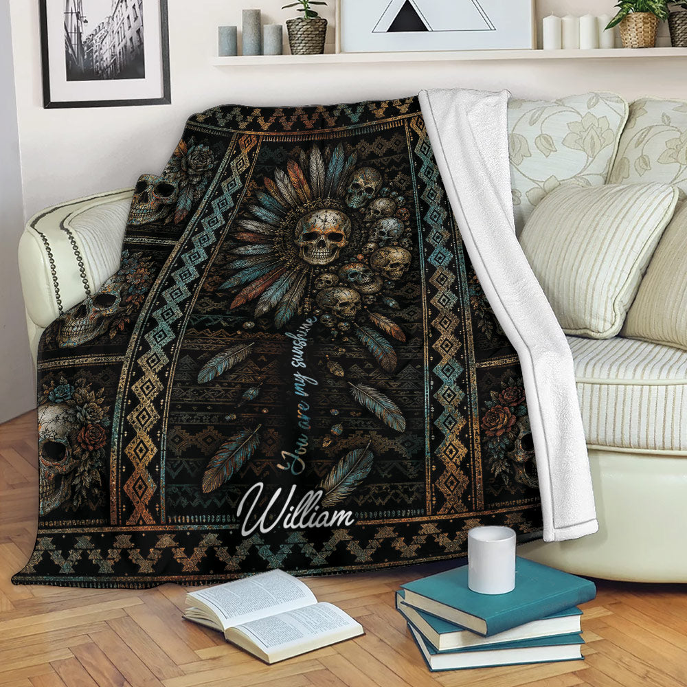 Skull blanket draped over a sofa, featuring ornate floral skull artwork in dark earthy colors
