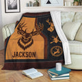 Hunting throw blanket displayed on a sofa with deer artwork and rustic outdoor-inspired colors