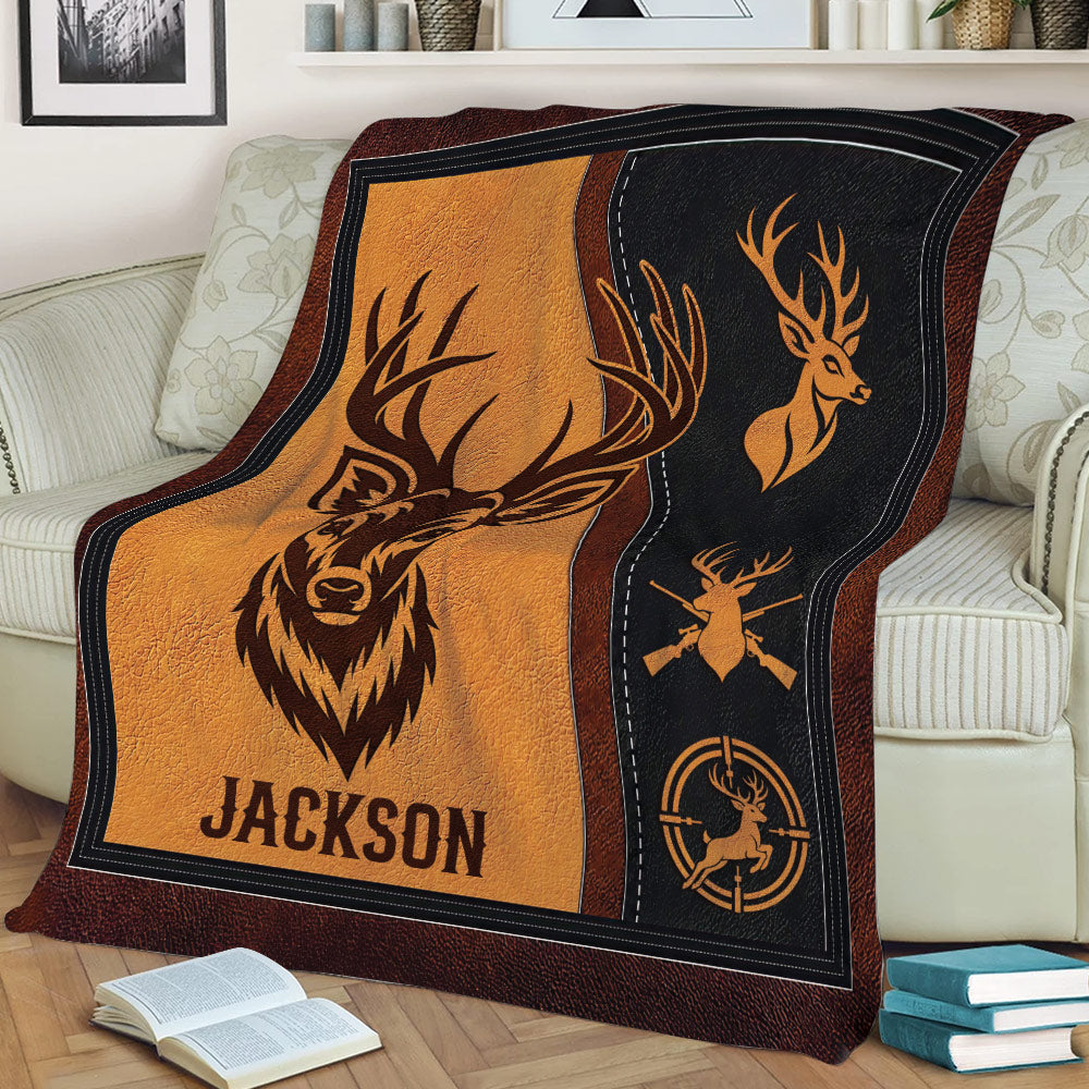 Rustic hunting throw blanket draped over a sofa with stylized deer and outdoor artwork