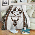 Deer hunting throw blanket displayed on a couch with camouflage accents and rustic wildlife artwork