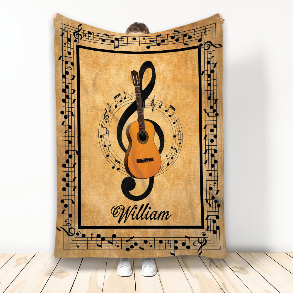 Guitar throw blanket with acoustic guitar, treble clef, and musical notes in a warm vintage-inspired design