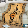 Guitar and music note blanket draped over a couch, featuring treble clef artwork and a decorative music border