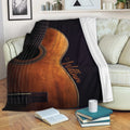 Acoustic guitar throw blanket draped over a sofa in a cozy living room setting